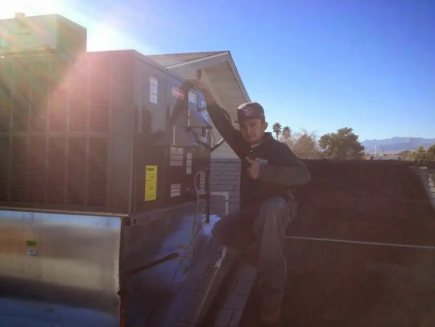 HVAC technician performing AC Tune-Up on a rooftop unit in Homosassa Springs